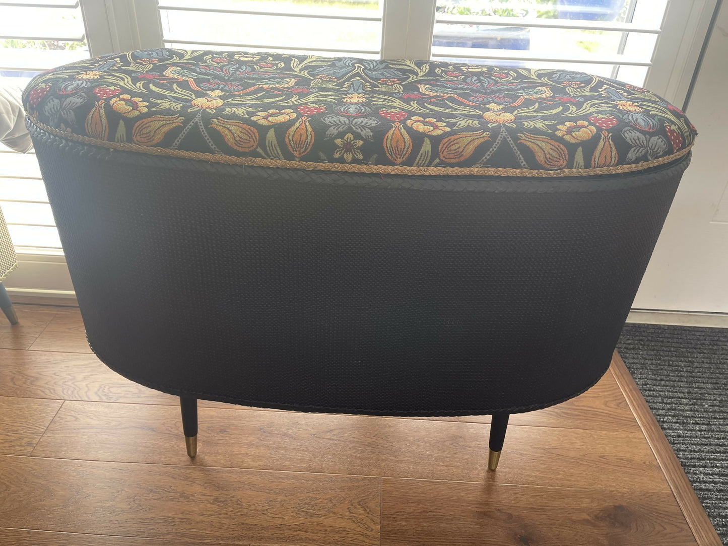 Black oval mid century modern ottoman - black paint William Morris style fabric