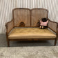 Very attractive and unique antique gold-colored cane bergère two-seater sofa.