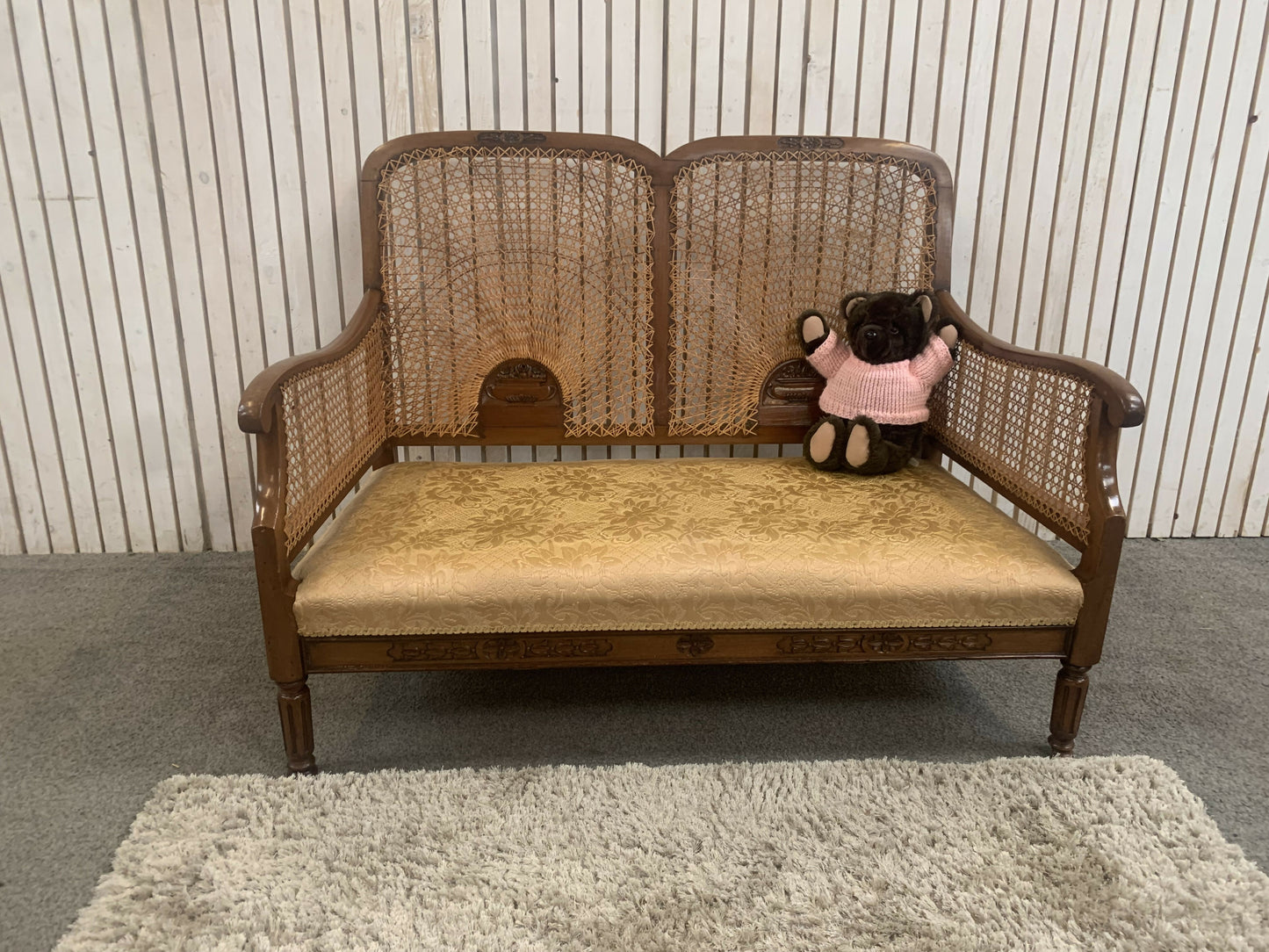 Very attractive and unique antique gold-colored cane bergère two-seater sofa.