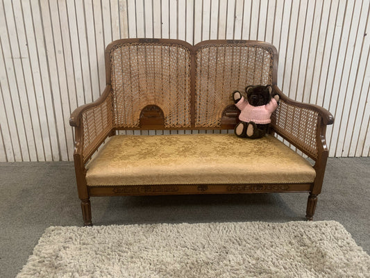 Very attractive and unique antique gold-colored cane bergère two-seater sofa.