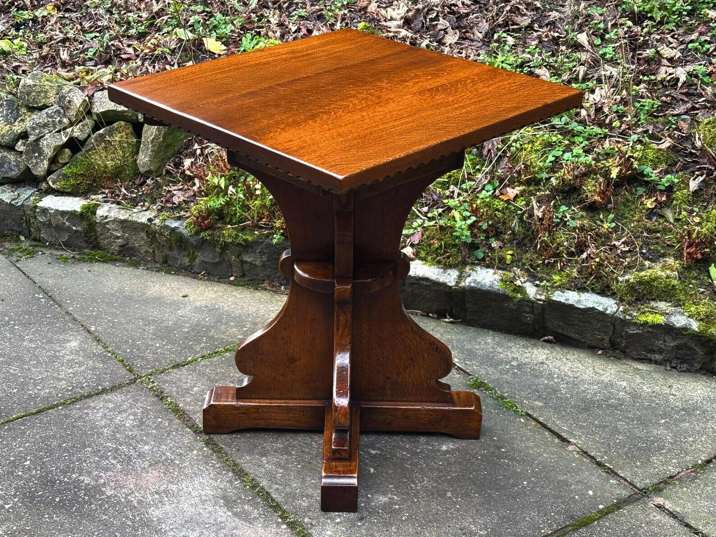 A RUPERT GRIFFITHS MONASTIC CARVED SOLID OAK LAMP TABLE / PLANT STAND