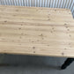 Pine dining table with a black base and a lacquered pine top.