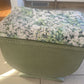 Small mid century Ottoman storage and seat. Sage green paint makes you choose the material.