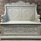 Edwardian antique Settle in solid oak with ornate carvings.
