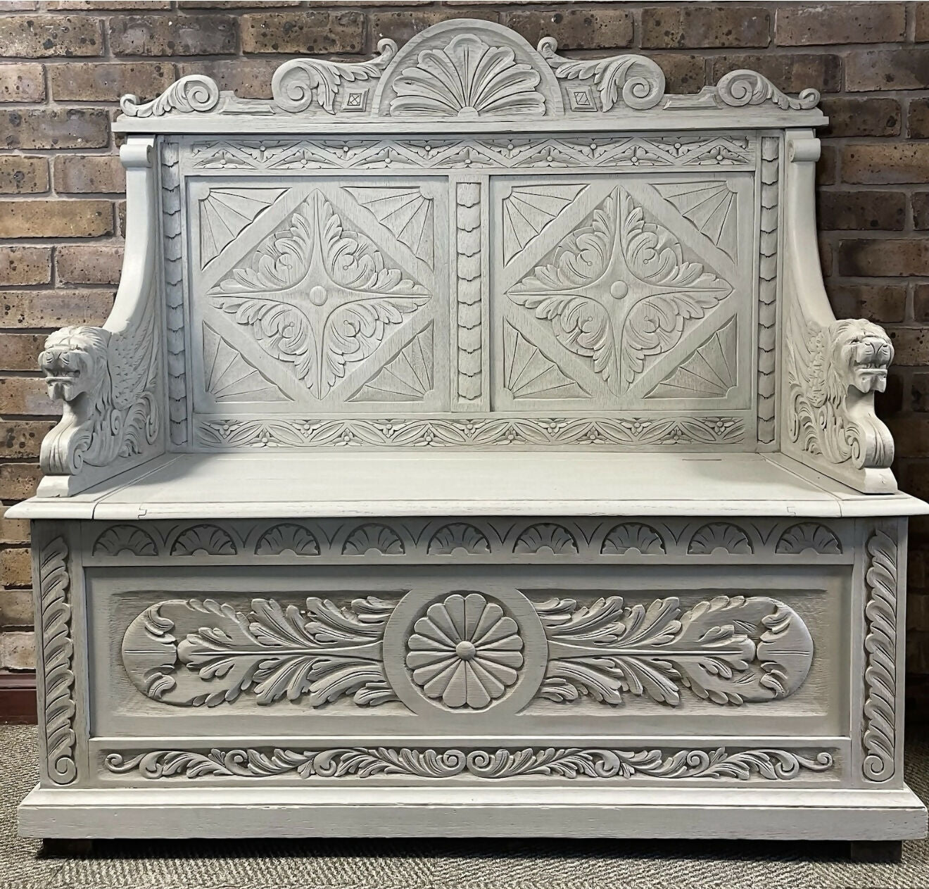 Edwardian antique Settle in solid oak with ornate carvings.