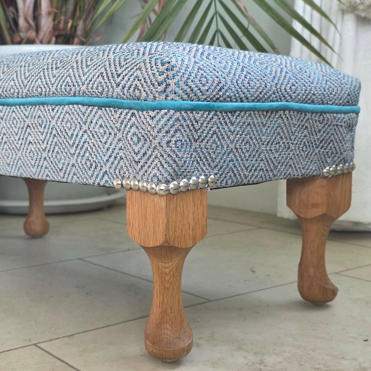 Long, Low Footstool, Restored and Reupholstered in Top Quality Woven Fabric.Teak wood feet. Newly Reupholstered.