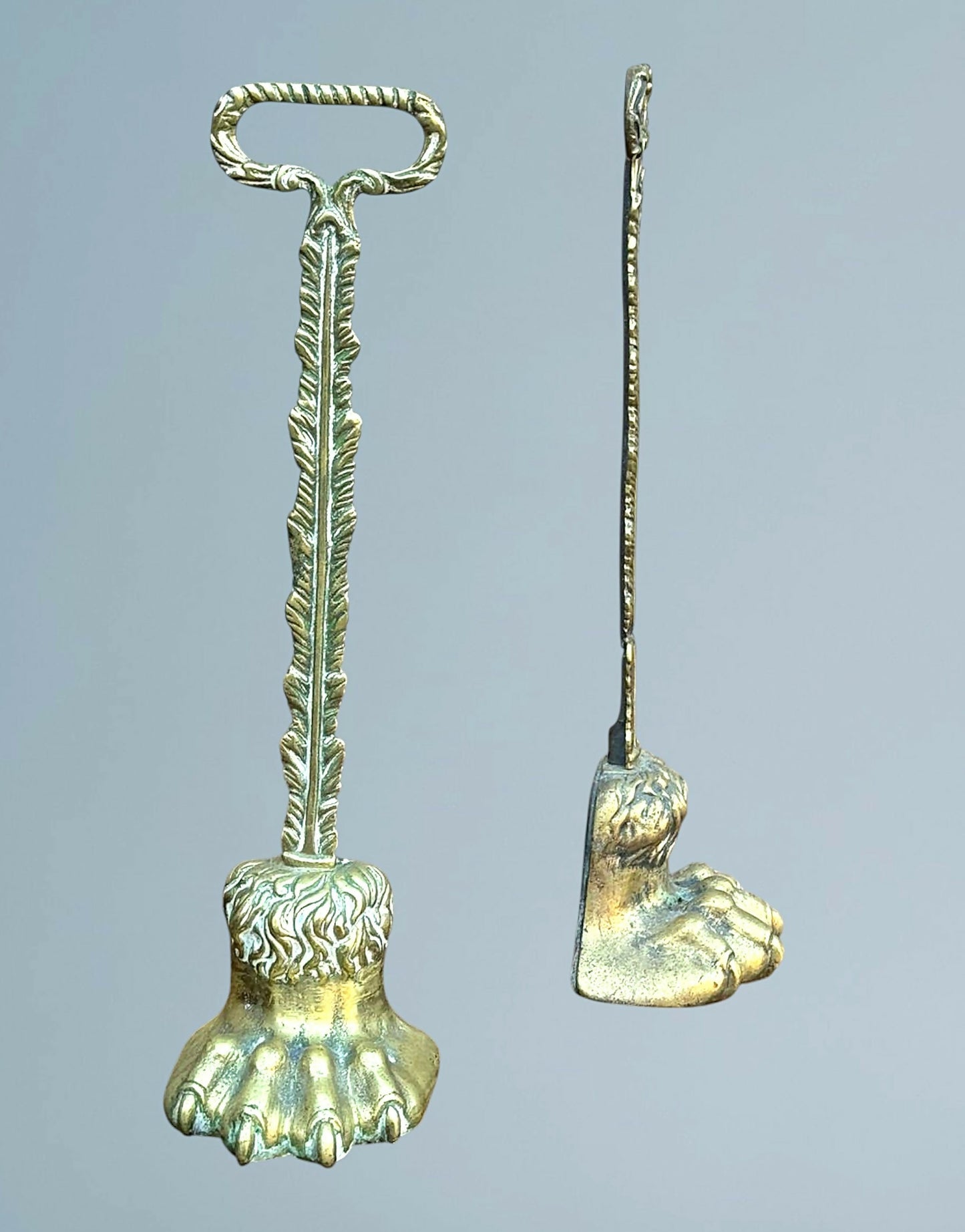 A Near Pair of 19th Century Brass Lion Paw Door Porters