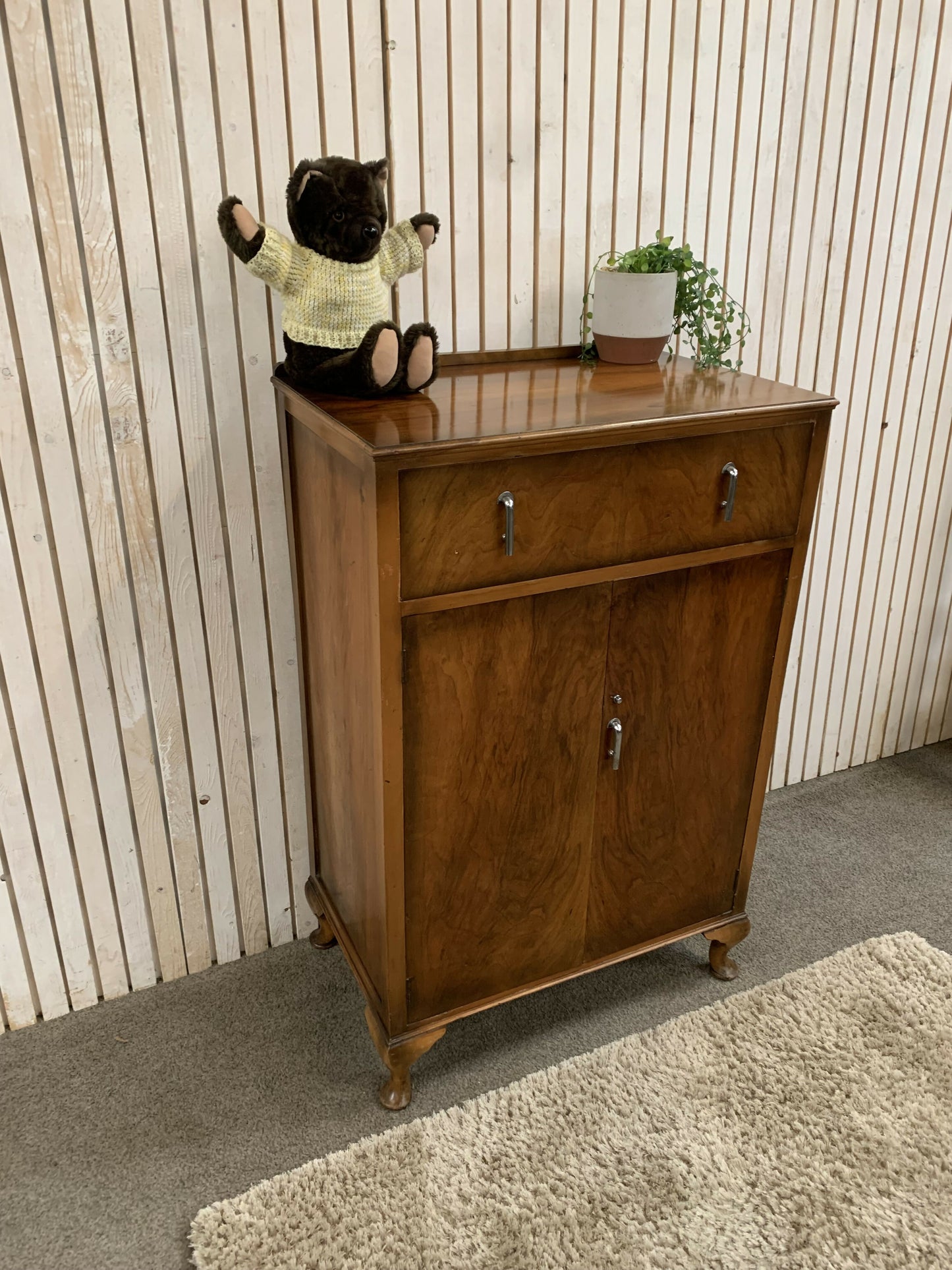 Vintage Art Deco burr walnut veneer cupboard featuring two doors and one drawer.