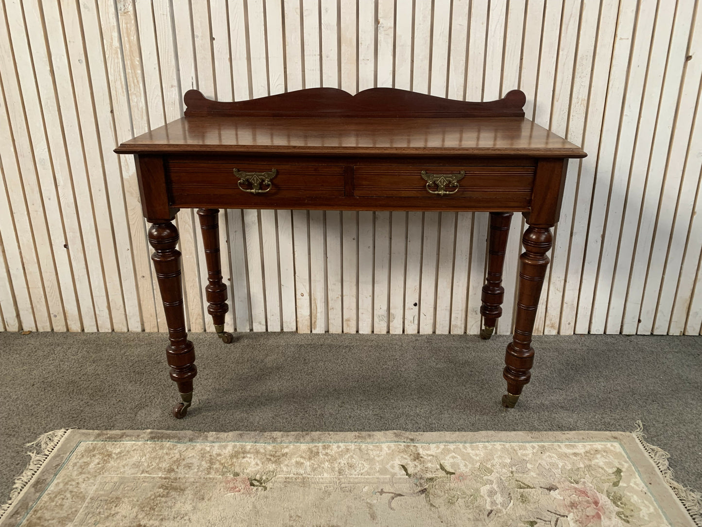 A Victorian Mahogany Writing Table/Desk With Drawer on castors.