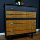 mid-century-teak-drawers-black-teal-design-gold-handles