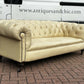 Vintage Victorian Buttoned Back Chesterfield Sofa In Leather On Brass Castors.