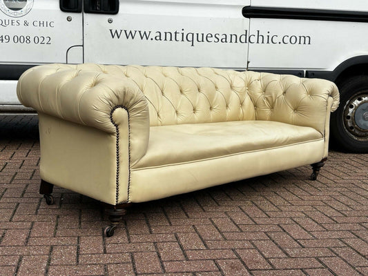 Vintage Victorian Buttoned Back Chesterfield Sofa In Leather On Brass Castors.