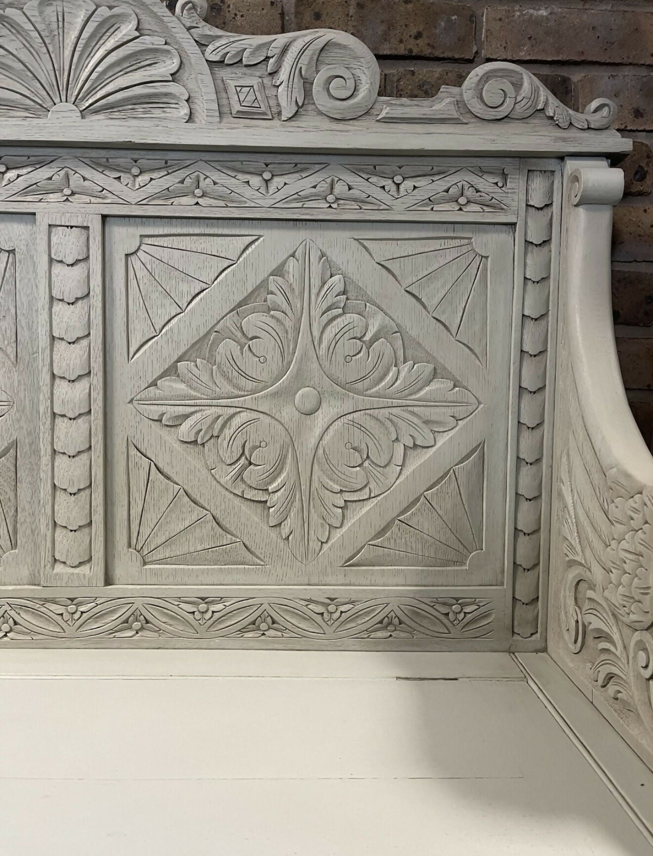 Edwardian antique Settle in solid oak with ornate carvings.