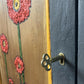 Dark grey wooden storage cabinet with hand carved flowers and linen interior