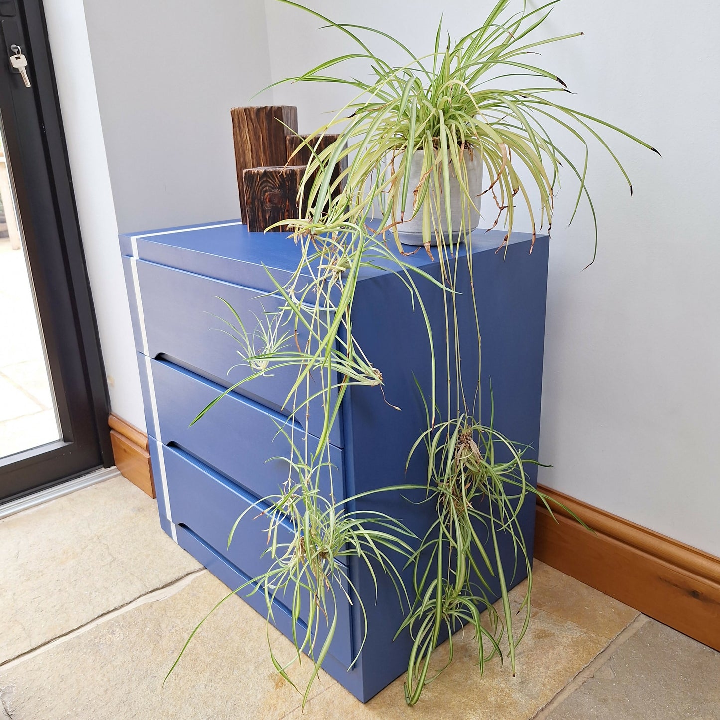 Small Simple Blue Chest Of Drawers With A White Stripe