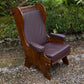 A NIGEL RUPERT GRIFFITHS MONASTIC CARVED OAK LEATHER FIRESIDE CHAIR / ARMCHAIR