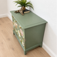 Sage green Stag Minstrel chest of drawers with neutral floral design. 3 over 2. Sideboard, dresser, bedside table