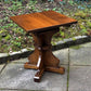 A RUPERT GRIFFITHS MONASTIC CARVED SOLID OAK LAMP TABLE / PLANT STAND
