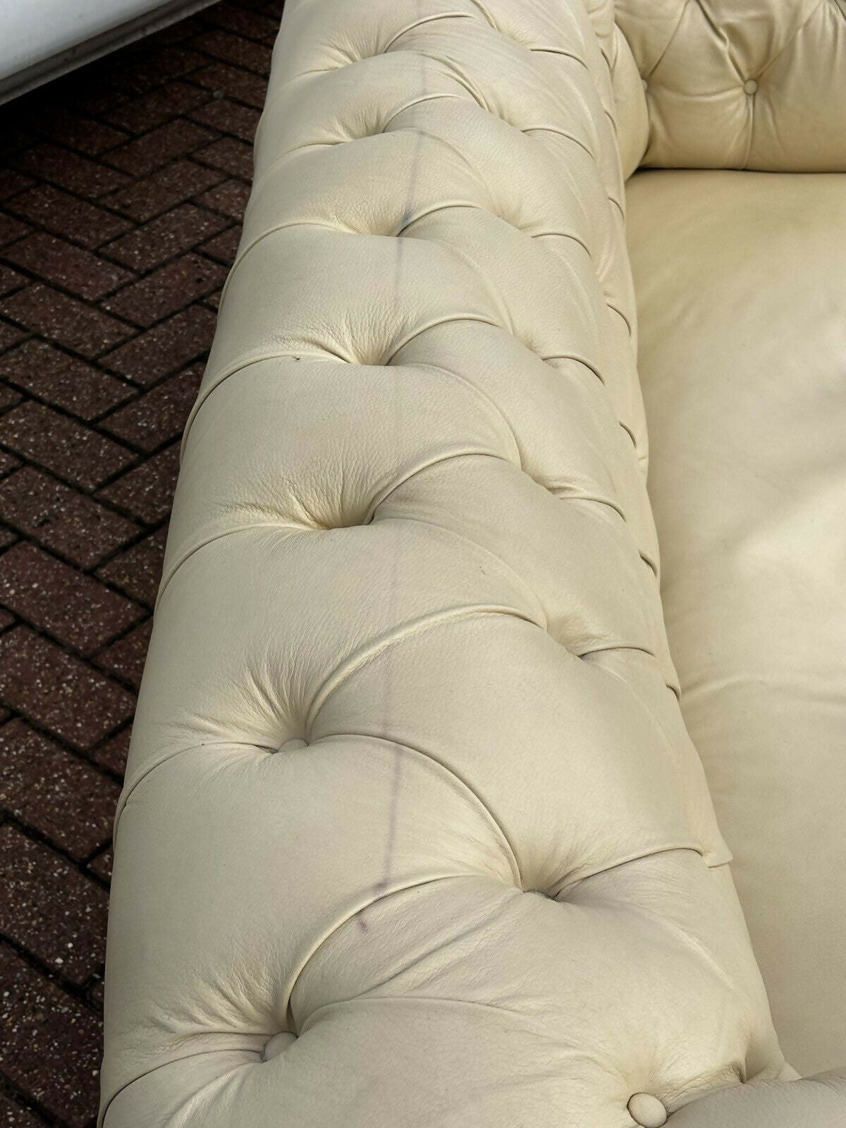 Vintage Victorian Buttoned Back Chesterfield Sofa In Leather On Brass Castors.