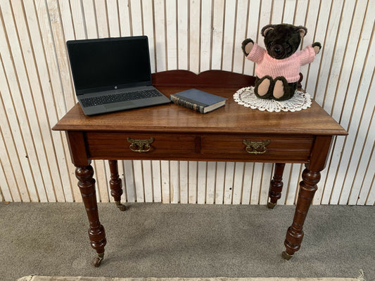 A Victorian Mahogany Writing Table/Desk With Drawer on castors.