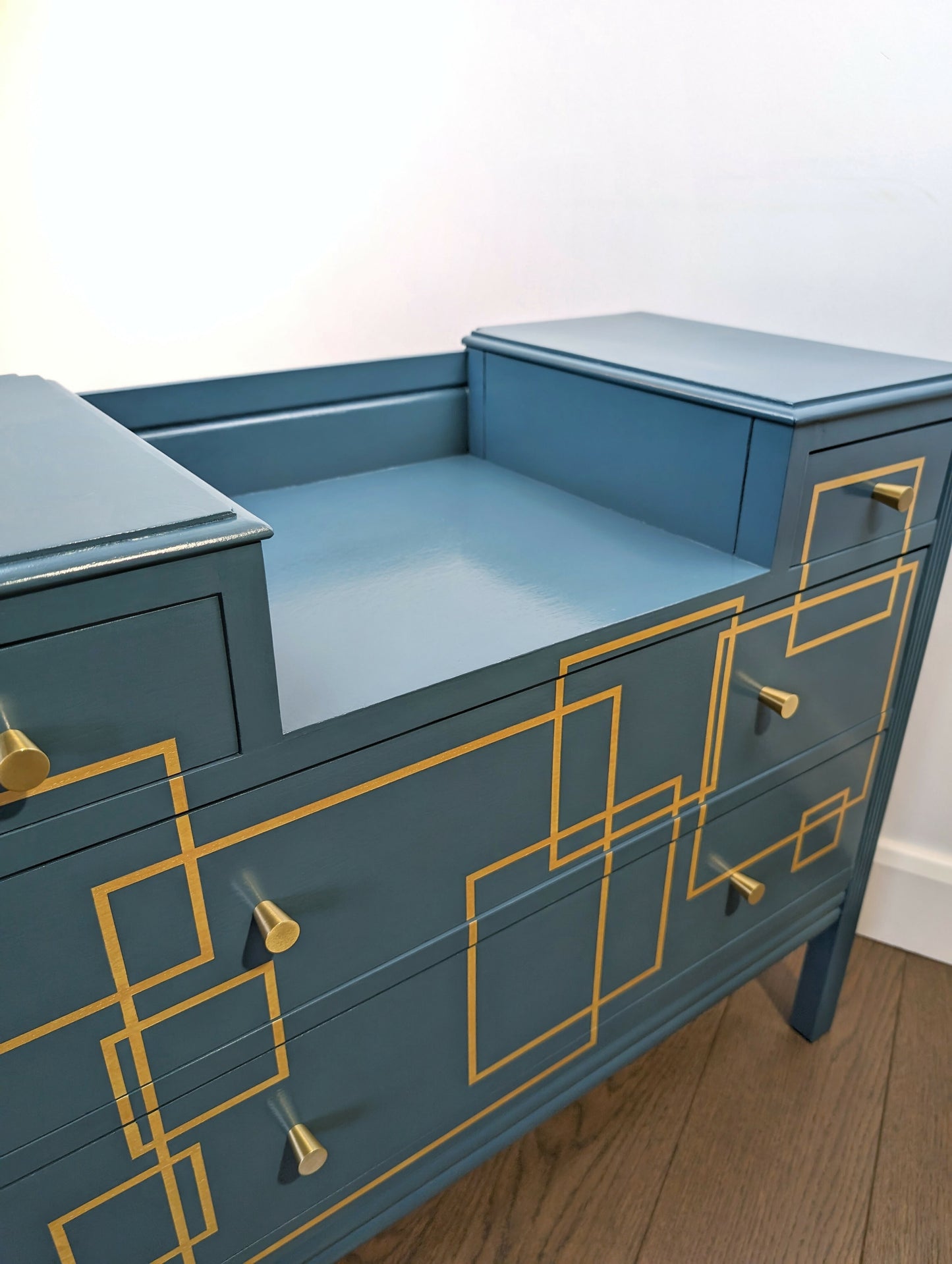 Blue and gold chest of drawers with geometric pattern and original mirrors