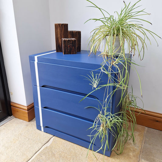 Small Simple Blue Chest Of Drawers With A White Stripe