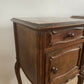 A near pair of antique French walnut and marble bedside tables
