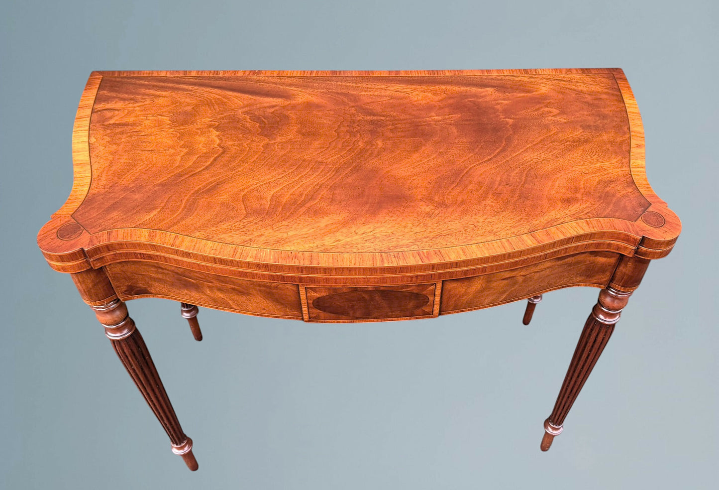 A Mahogany Serpentine Fronted Turn Over Top Tea Table