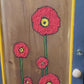 Dark grey wooden storage cabinet with hand carved flowers and linen interior