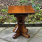 A RUPERT GRIFFITHS MONASTIC CARVED SOLID OAK LAMP TABLE / PLANT STAND