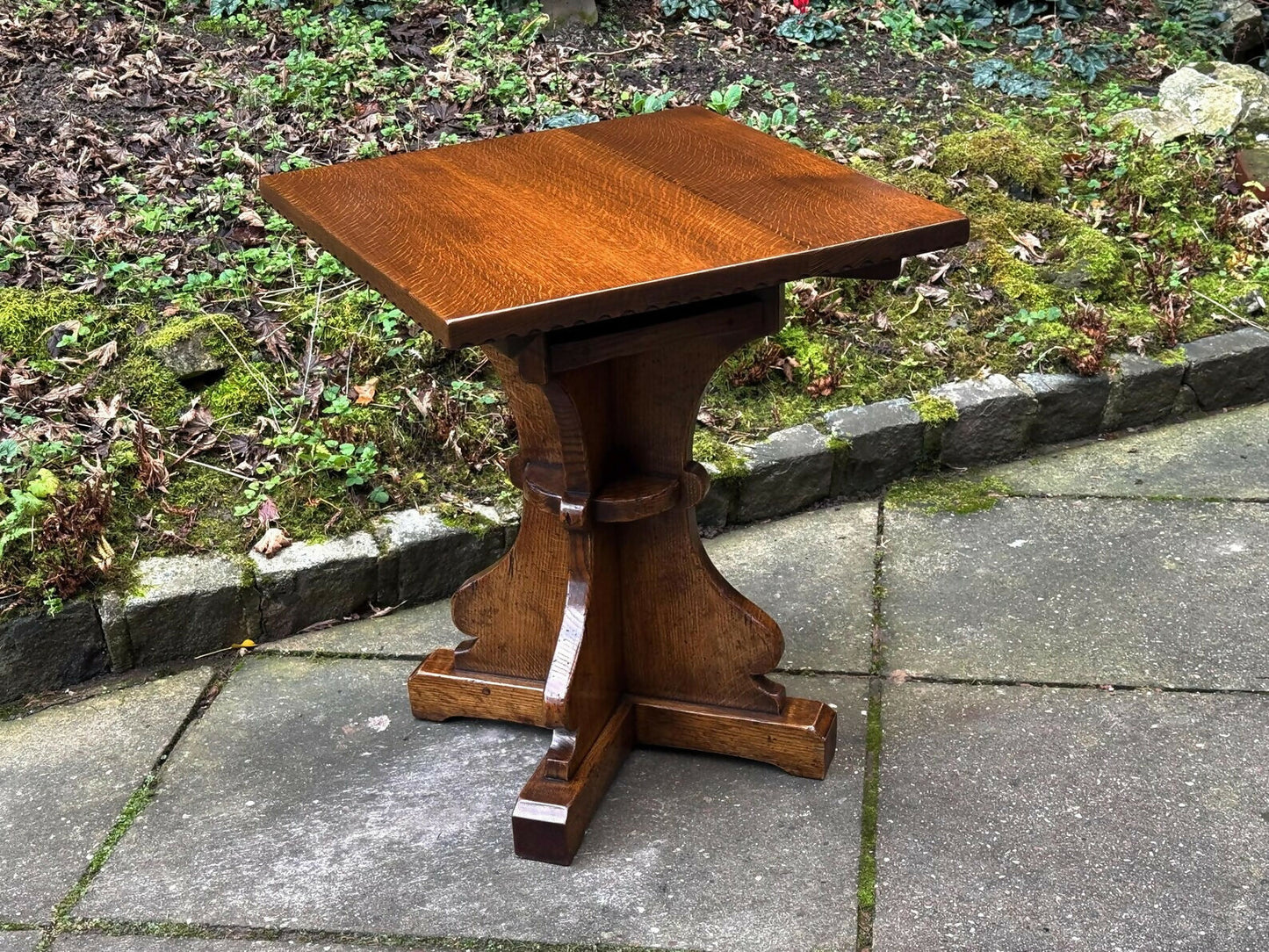 A RUPERT GRIFFITHS MONASTIC CARVED SOLID OAK LAMP TABLE / PLANT STAND