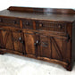 A NIGEL RUPERT GRIFFITHS MONASTIC CARVED OAK DRESSER BASE / SIDEBOARD / CABINET / CUPBOARD.
