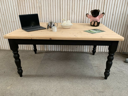 Pine dining table with a black base and a lacquered pine top.