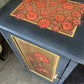 Dark grey wooden storage cabinet with hand carved flowers and linen interior