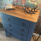 Vintage Harris Lebus 4 Drawer Chest With A Natural Wood Top And Brass Drop Handles.