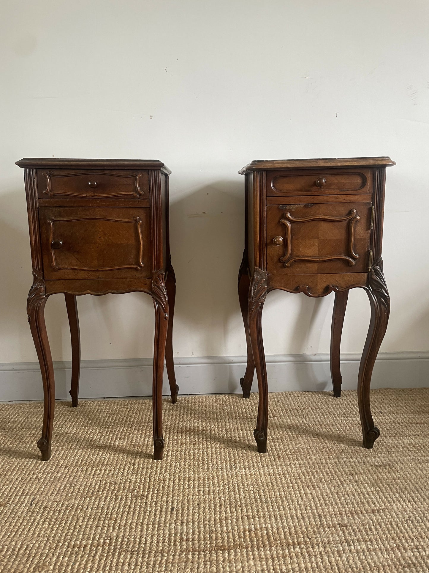 A near pair of antique French walnut and marble bedside tables