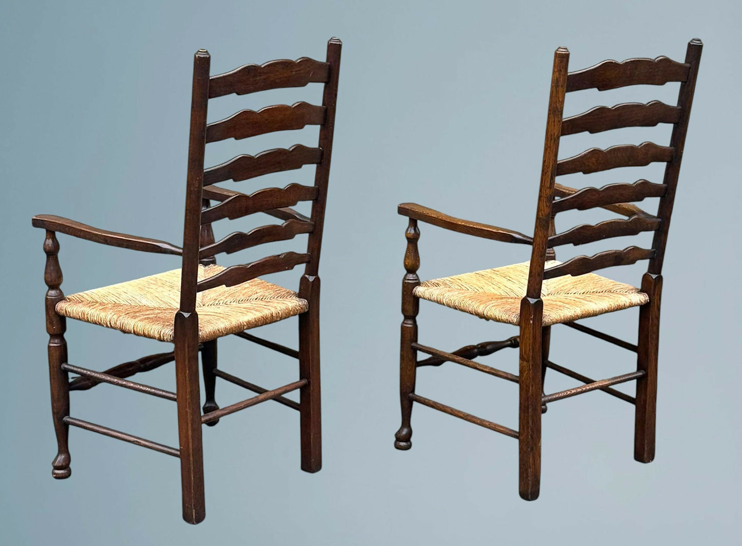 A Pair of Oak Ladder Back Rush Seated Armchairs