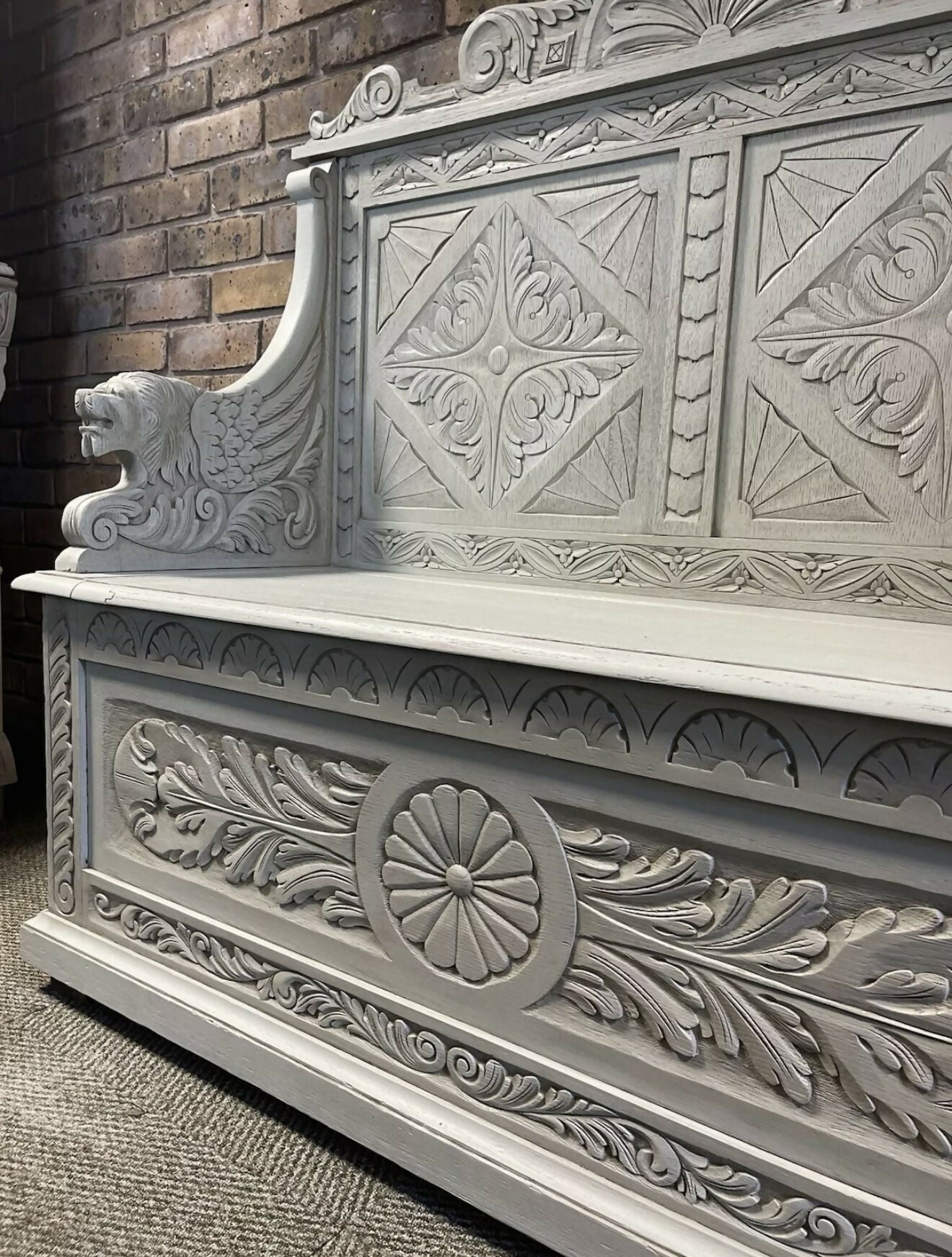 Edwardian antique Settle in solid oak with ornate carvings.