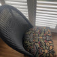 Lloyd loom low accent chair. Black satin paint and William morris style fabric