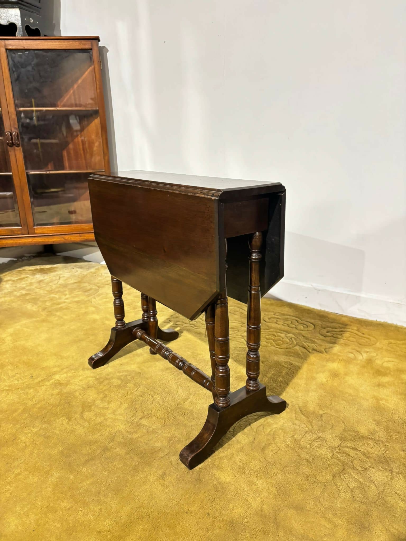 Edwardian mahogany table of small proportions resting on turned legs.00