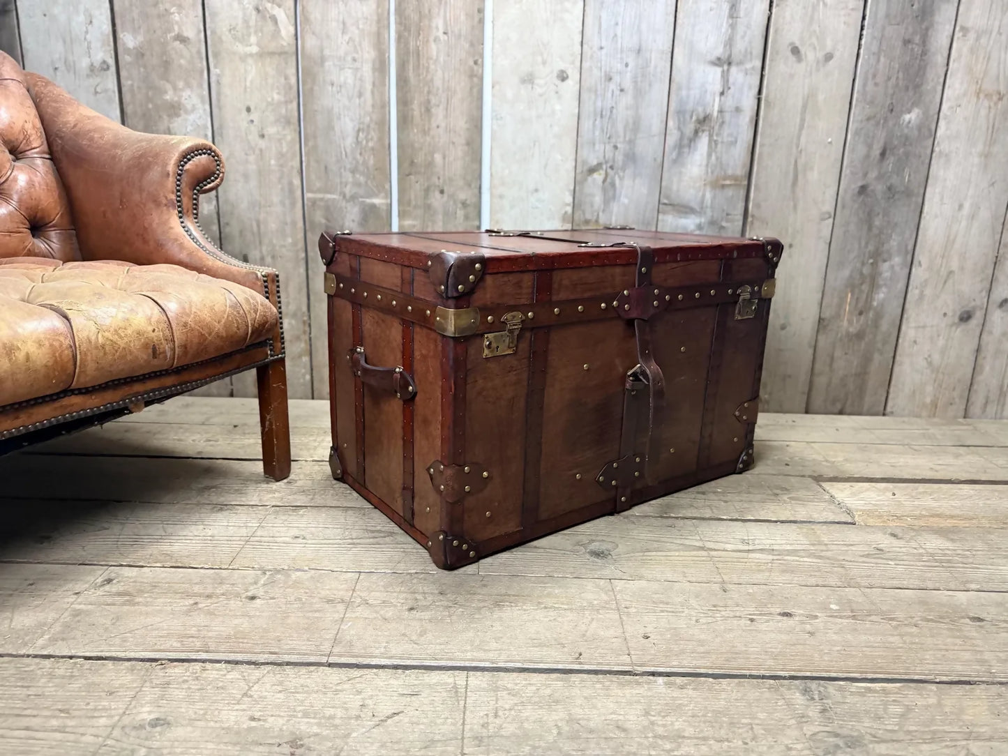 Antique leather trimmed chestnut brown campaign chest