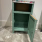 Green painted glass topped cabinet. Beautiful fabric accent top.