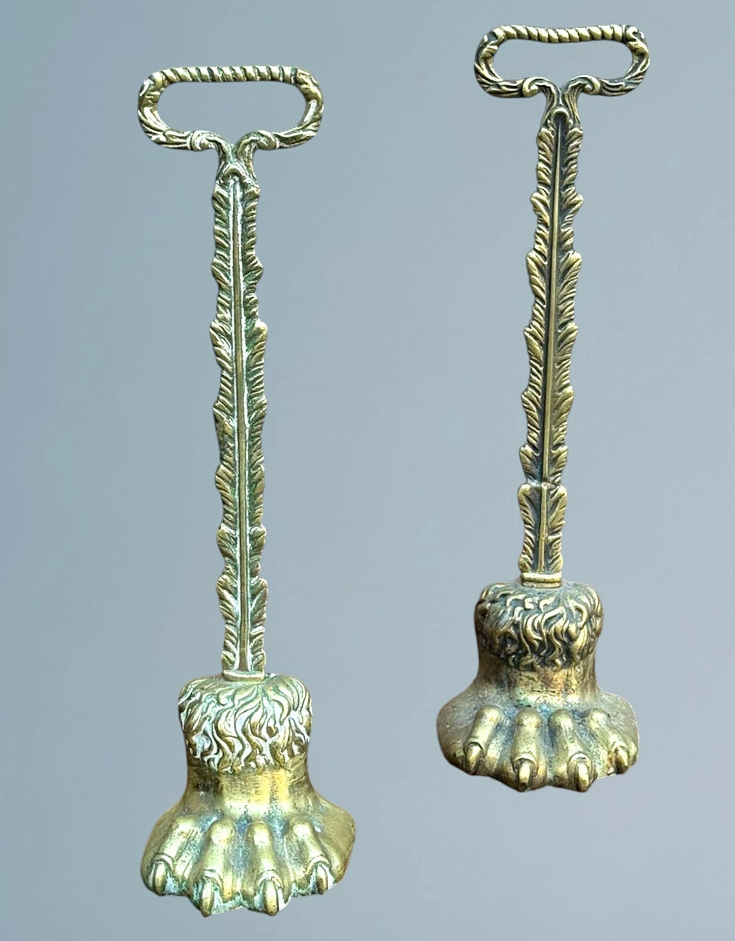A Near Pair of 19th Century Brass Lion Paw Door Porters