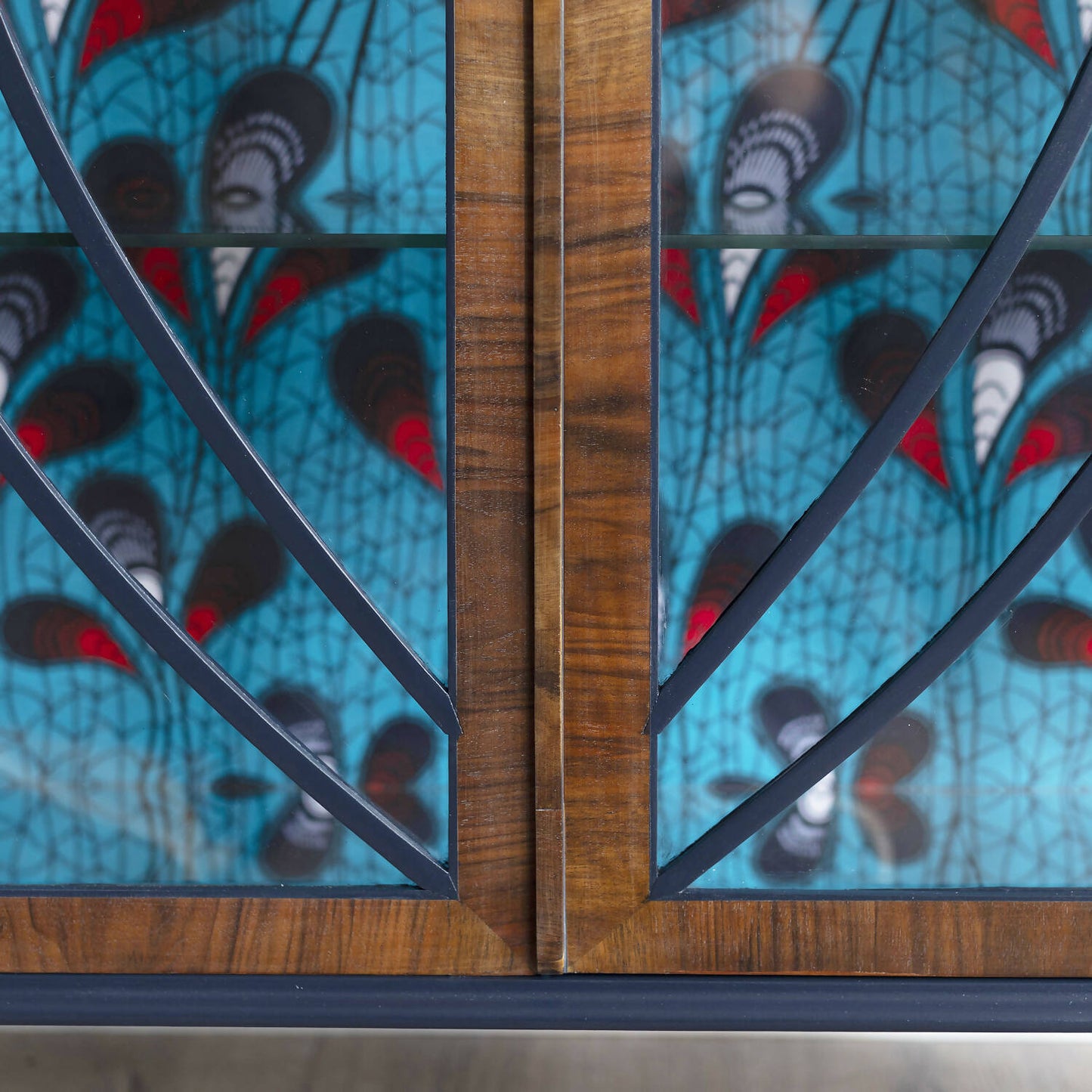 Blue Art Deco drinks cabinet, distinguished by its heart shape and decoupage featuring an African-inspired peacock feather fabric. Sold, commission available.