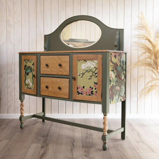 An exceptional vintage sideboard in a unique olive green hue, featuring an oval mirror and decoupaged in original Rockbird fabric.