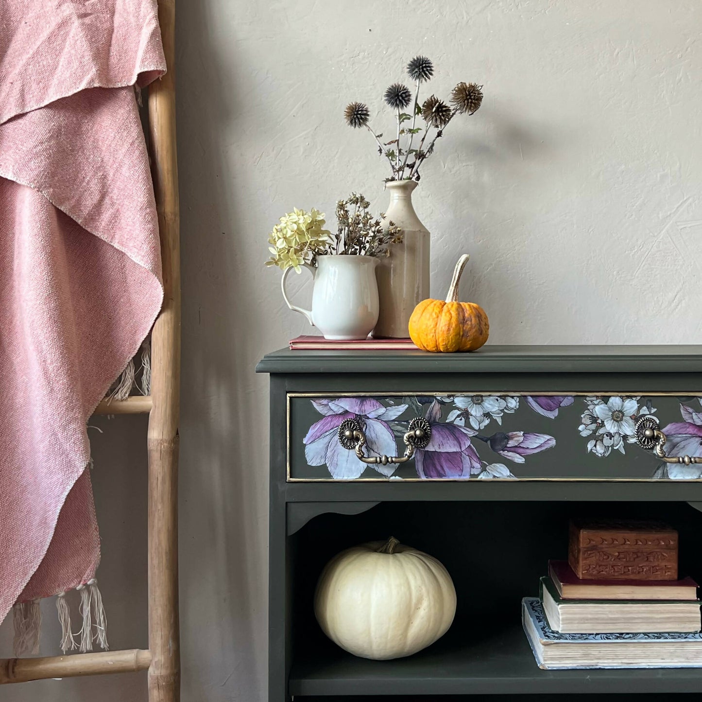 Vintage bookcase painted green with floral detail