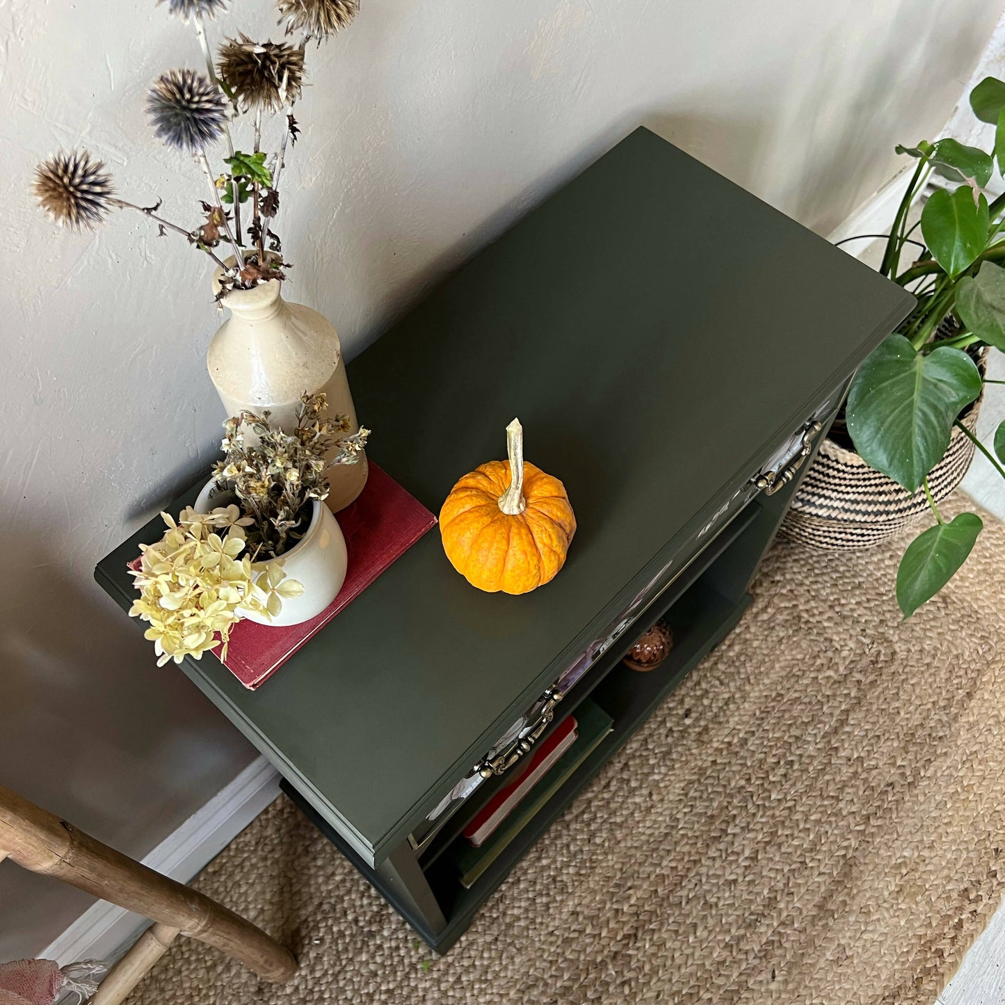 Vintage bookcase painted green with floral detail