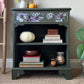 Vintage bookcase painted green with floral detail