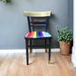 Hand painted school chair with vibrant rainbow stripe seat and gold leaf backrest. Abstract art design.