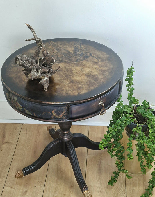 **Sold**Vintage Hand painted round side table, coffee table, Pedestal Drum Table, Round coffee table. Black table, Navy Gold Amber. Two drawers.